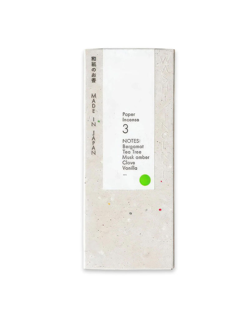 1 of 4.  White paper incense stick packaging with text and green circle on a white background
