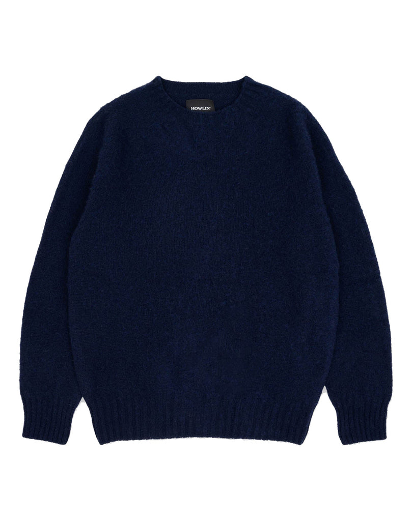 Photo 1 of 2.  Navy blue sweater on a white background with a classic collar and ribbed cuff.