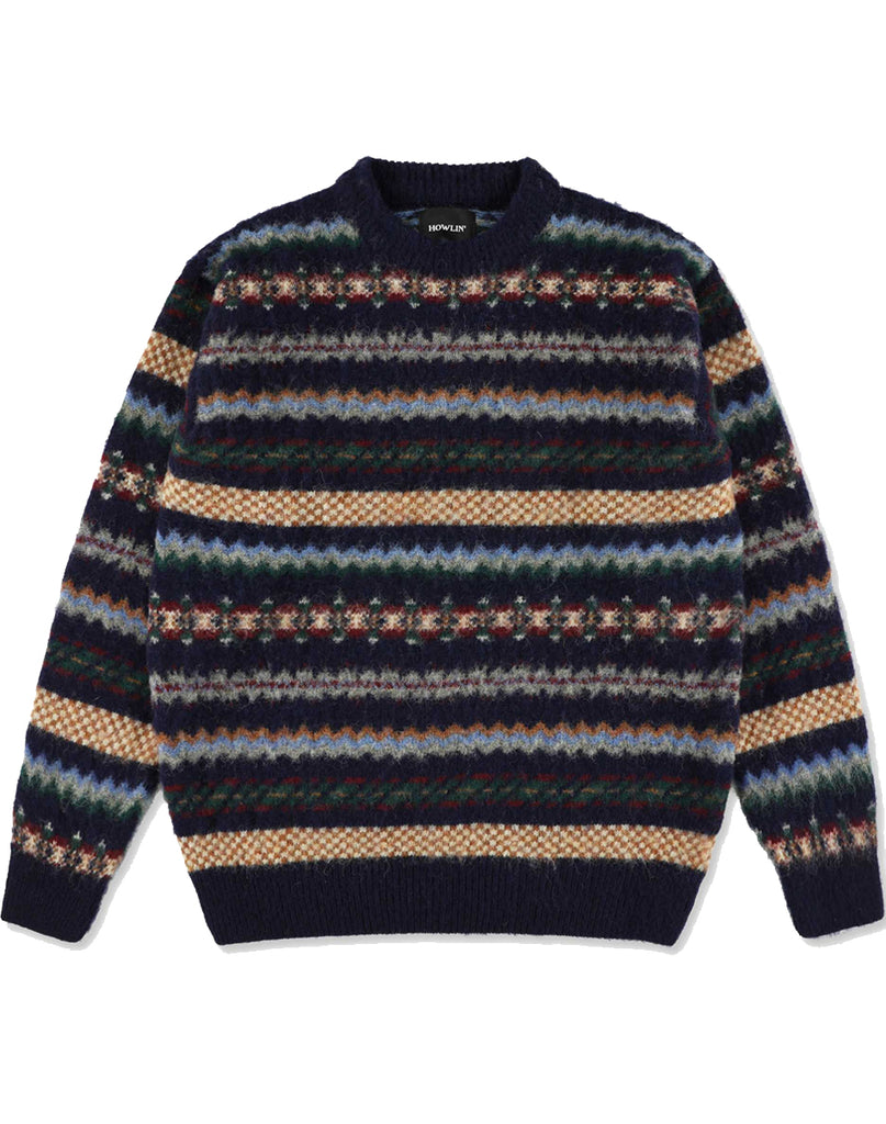 Howlin' Woolen Wonder sweater in a Fair isle pattern.  Fair-isle colors of white, light blue, navy, orange, green , red and grey.  Blue solid collar and cuffs.  Slide 1 of  4