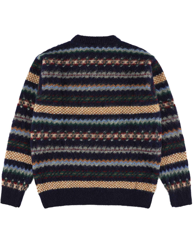 Howlin' Woolen Wonder sweater in a Fair isle pattern rear view.  Fair-isle colors of white, light blue, navy, orange, green , red and grey.  Blue solid collar and cuffs.  Slide 2 of  4