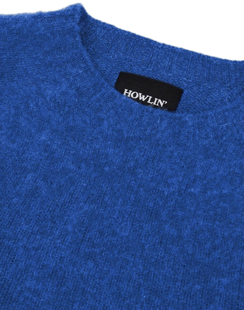Photo 2 of 2.  Close-up of a blue wool sweater with a 'HOWLIN' label.