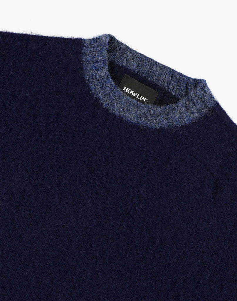 Photo 2 of 3.  Navy blue wool sweater with light blue trim collar with a "Howlin" label