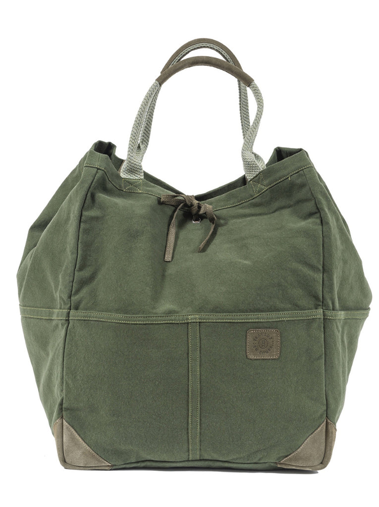 Front view of the green large tote bag with two curved handles with leather trim.  Khaki green leather tie in the center of bag with khaki green logo patch on center right of bag.  Slide 1 of 5