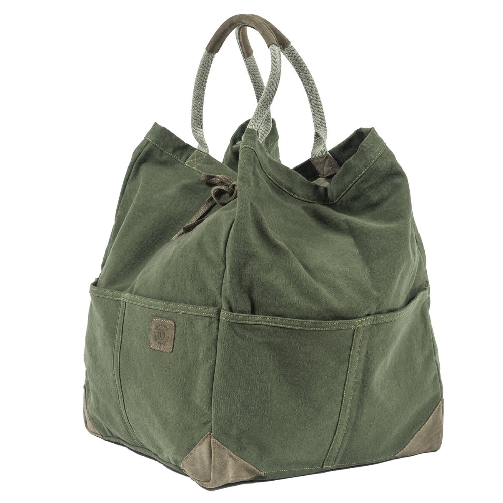 3/4 angle view of the green large tote bag with two curved handles with leather trim.  Khaki green leather tie in the center of bag with khaki green logo patch on center right of bag.  Slide 3 of 5