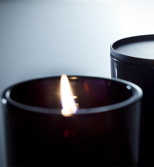 02 Owari candle shows closeup lit candle with adjacent candle with black metal lid on top.