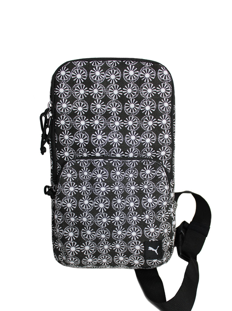 PUMA x ODIN astro wheel all over pattern.  Print is in white and base is black canvas.  Zip middle pocket at center of the bag with zippers having cord pulls.  Slide 1 of 2