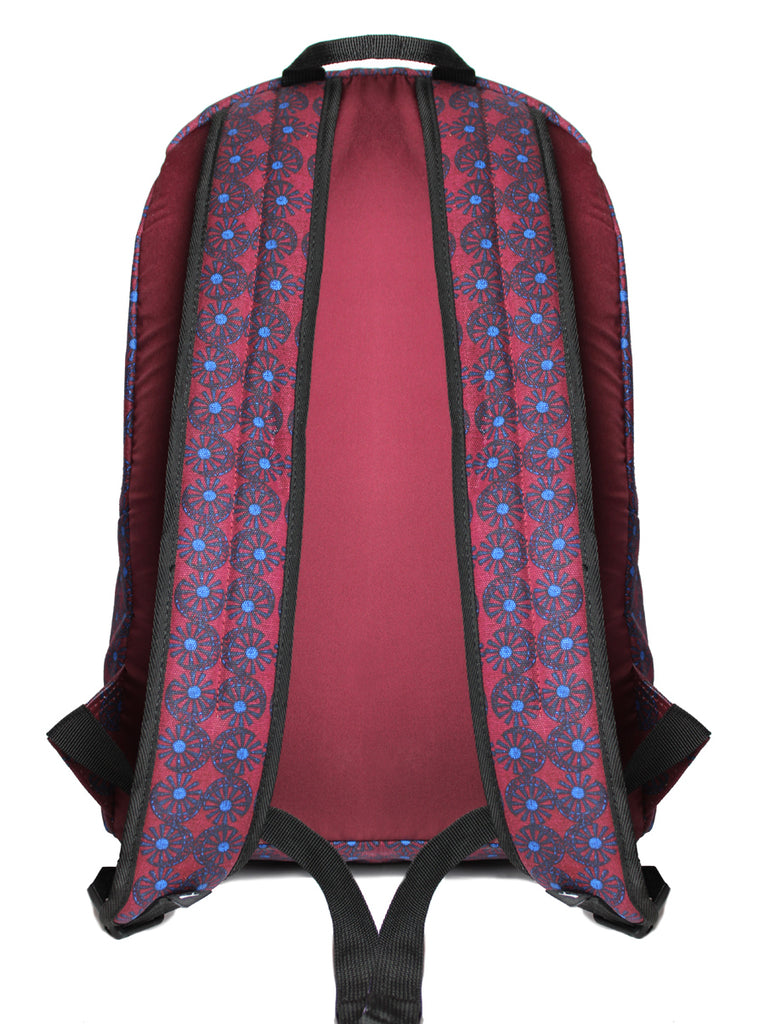 Back view of the Puma x Odin wheel backpack with pattern on straps.  Padded burgandy back and padded wheel pattern straps with black trim and adjustable straps.  Slide 3 of 4